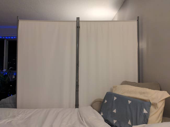 the room divider in the white set up in a dorm room