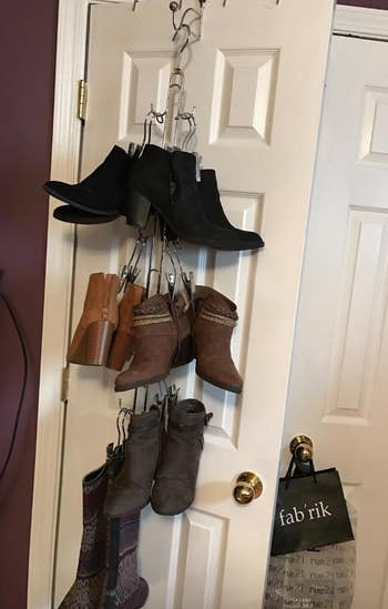 reviewer photo of vertical boot rack with boots, mounted on door
