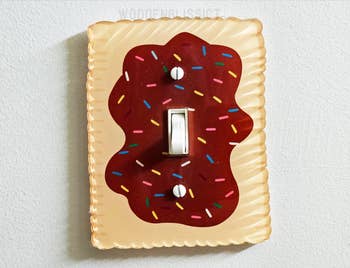 Light power   screen  styled similar  a cooky  with reddish  icing and sprinkles, perfect  for playful location  decor
