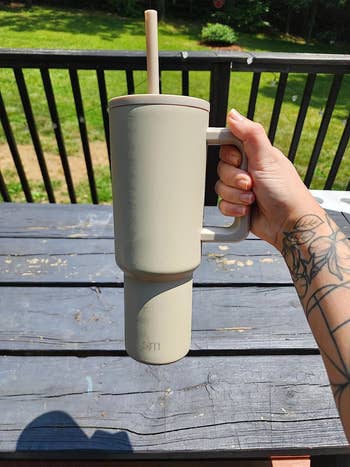 reviewer holding up   the beige tumblr