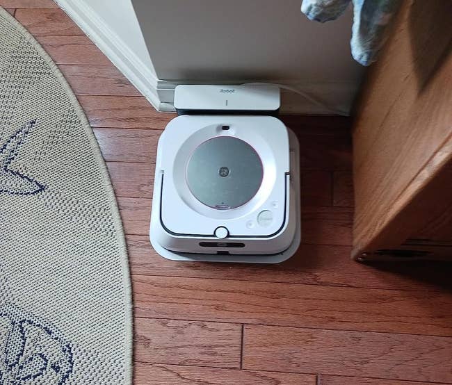 reviewer photo of the white robot mop on its stand