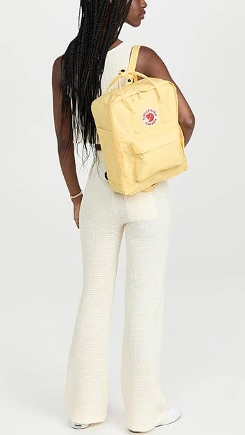 model wearing the backpack in light yellow