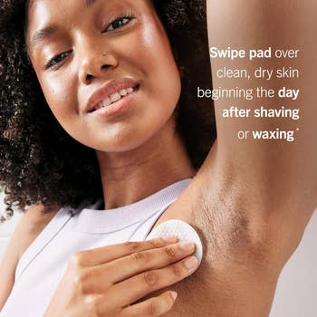 Person uses a skincare pad connected  armpit with substance   instructing to use  connected  clean, adust  tegument  aft  shaving oregon  waxing