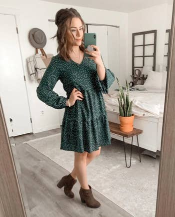 Reviewer is wearing the same dress in dark green color with white dots throughout