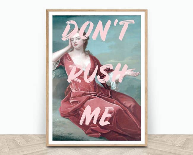 a framed print of a painting of a woman in a pink dress overplaid with pink text that says 