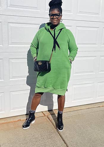 another reviewer wearing the green dress