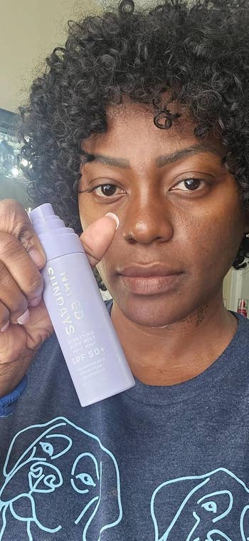 Person holding a vessel of SPF 50+ sunscreen, promoting skincare with a close-up absorption connected the product