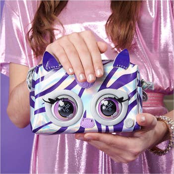 child model holding zebra purse