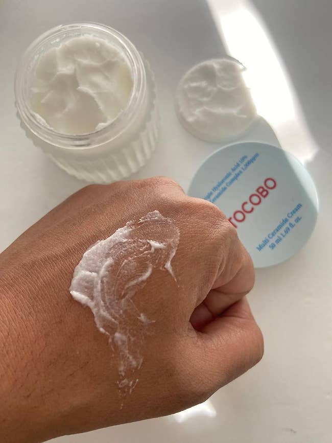reviewer with some of the moisturizer on their hand