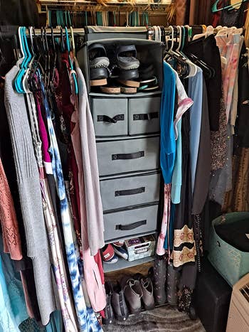 reviewer pic of soft gray closet organizer with some shelves and drawers on a closet rack