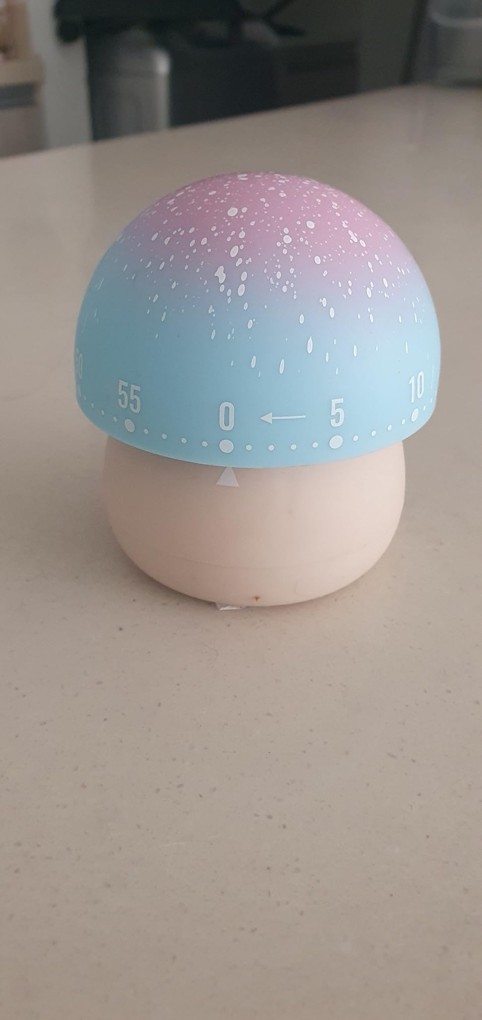 Kitchen timer shaped similar  a mushroom, blending into a gradient from bluish  to pinkish  connected  top. Numbers 0-60 are astir   the broadside  for mounting  time