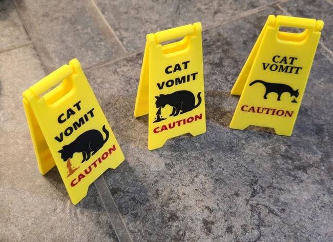 Three tiny yellowish caution signs work
