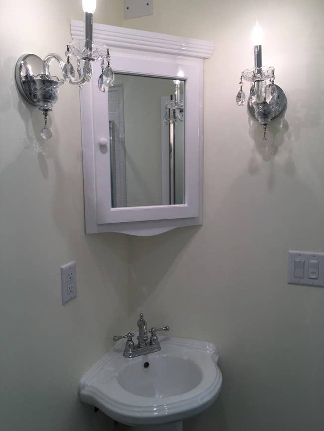 Reviewer image of white mini corner cabinet with mirror