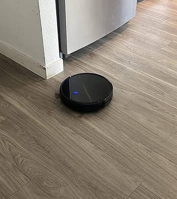 Robot vacuum on reviewer's hardwood floor