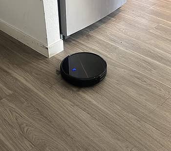 Robot vacuum on reviewer's hardwood floor