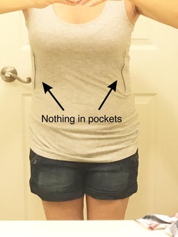 reviewer showing the tank in white with nothing in the pocket