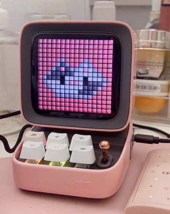 a reviewer photo of the bluetooth speaker in pink 