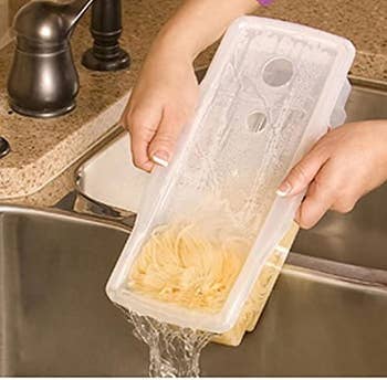 Model using the built-in strainer in the pasta maker to strain the water into the sink
