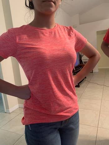 A reviewer wearing the shirt in pink