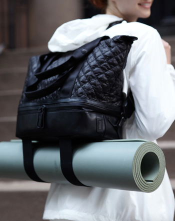 model wearing backpack sports carrying yoga mat in straps