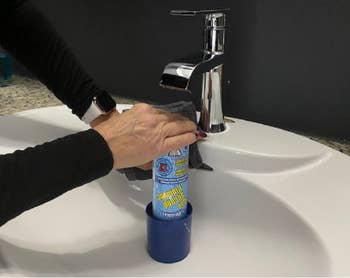 hands using it on a sink without the handle