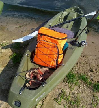 Reviewer image of orange backpack in green kayak