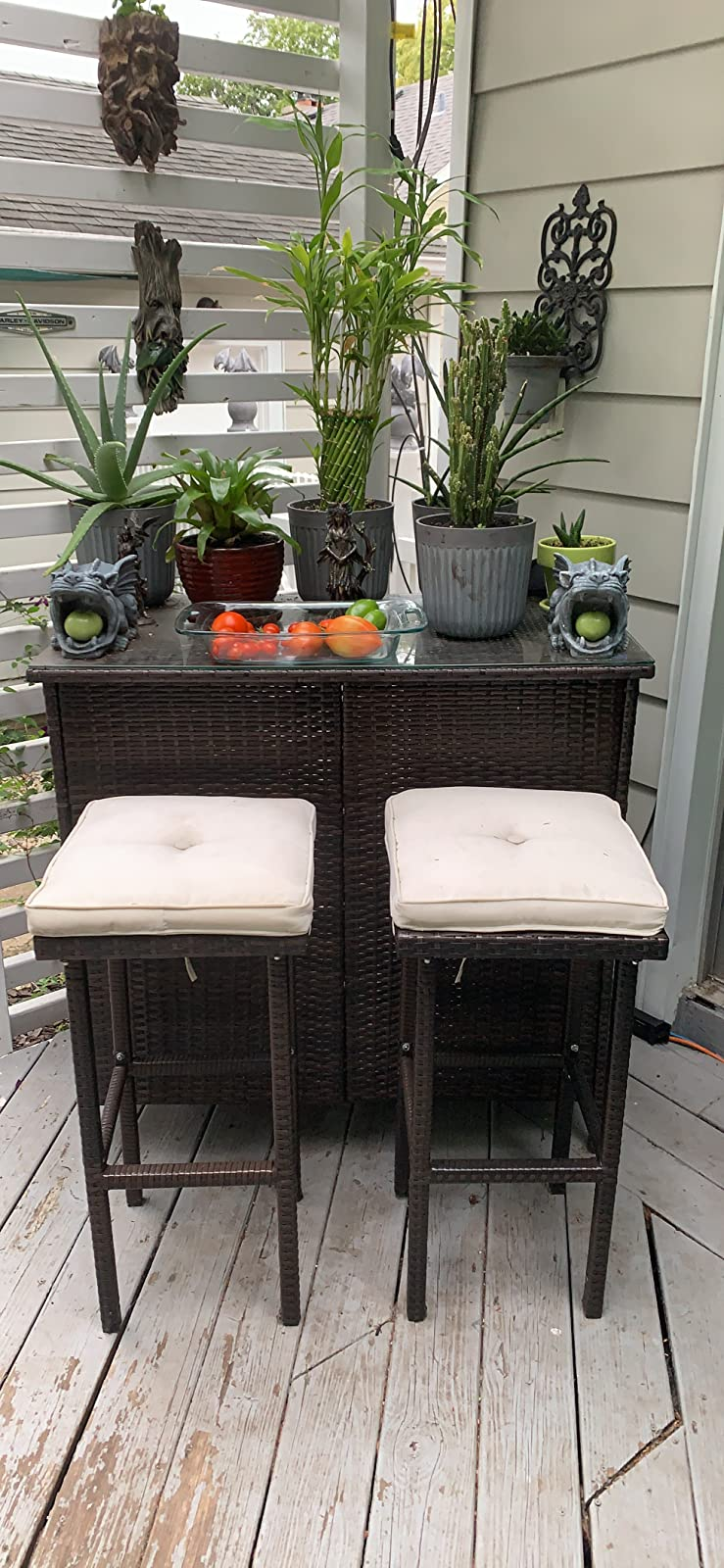another reviewer photo of the bar set with cream cushions topped with plants