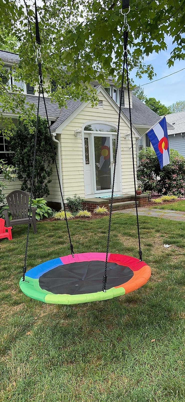 Circular histrion   plaything  hanging successful  a backyard with a location   successful  the background