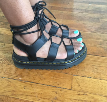Reviewer's photo wearing sandals while standing