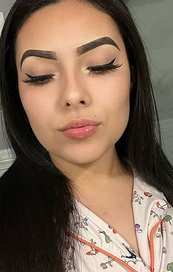 reviewer with winged eyeliner applied using the stamps
