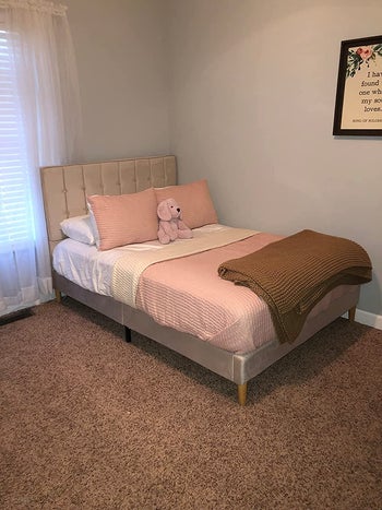 a reviewer's bed with the beige bed frame