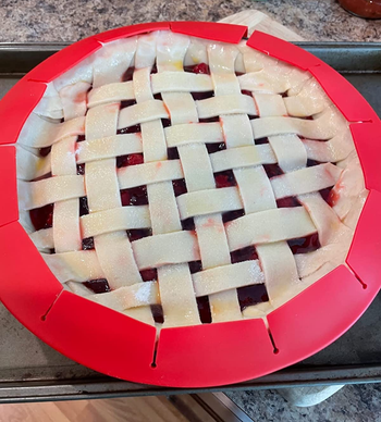 reviewer photo of an unbaked pie with the red pie crust shield on it
