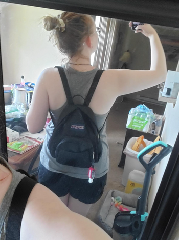 reviewer mirror selfie wearing black Jansport mini backpack