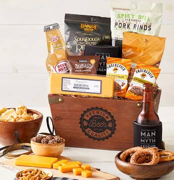 Gift basket with various snacks, including sourdough pretzels, pork rinds, beer nuts, cheese, and craft beer, ideal for a shopping article about gourmet food gifts