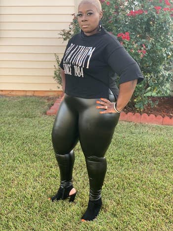 A reviewer wearing the leggings with a black t-shirt