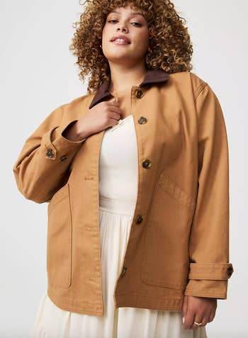 Person modeling a stylish, casual overgarment   implicit    a airy  dress