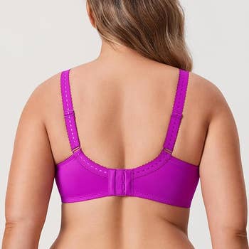 Person wearing an neon purple adjustable, supportive bra from the back.