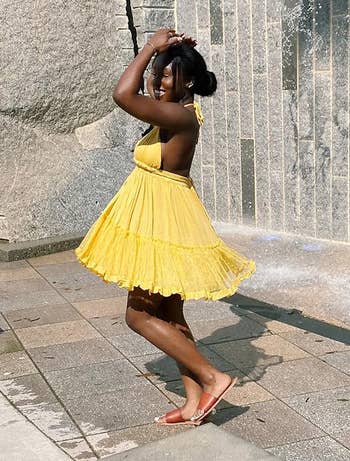 reviewer wearing yellowish  dress