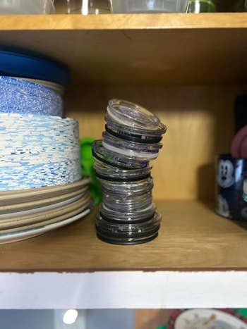 Stack of various-sized lids on a shelf