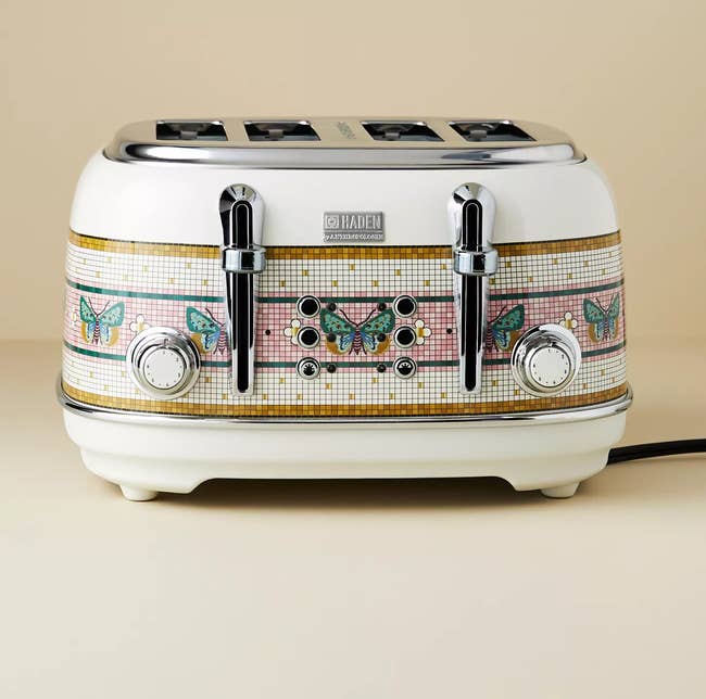 Vintage-style toaster with butterfly patterns, featuring 4 slots and chrome controls