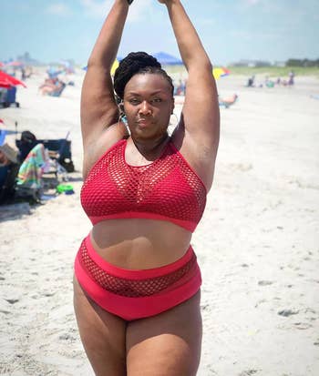 different reviewer wearing the fishnet bikini in red at the beach