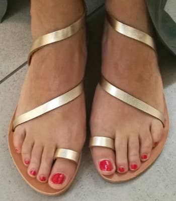 model wearing the sandals successful  gold