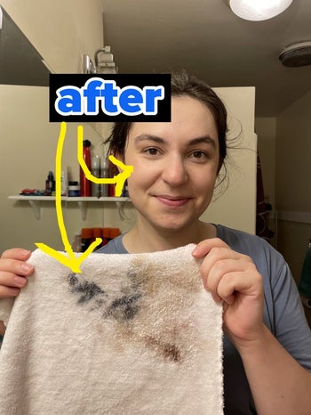 Me after using the cloth to remove my makeup, holding up the cloth, labeled 