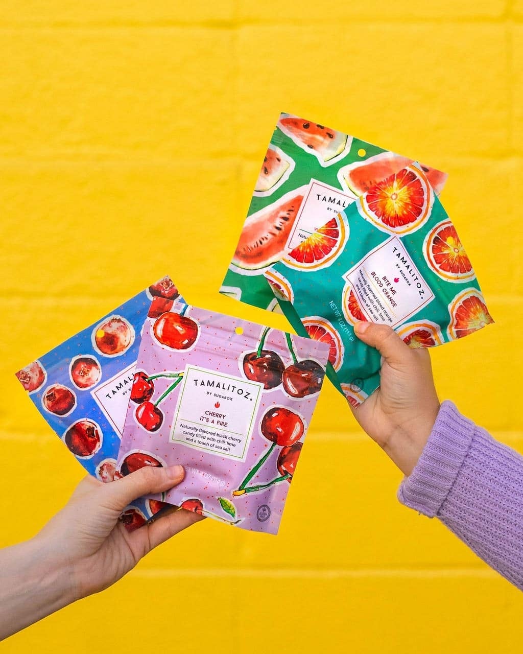 four bags with various fruits on it