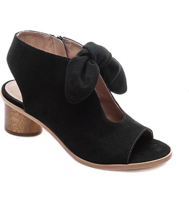 a black peep toe bootie with a bow