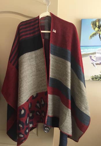 a reviewer's shawl featuring a mix of prints on a hanger 