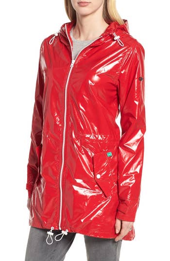 model wearing a shiny red nylon raincoat