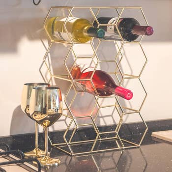 Gold hexagon wine rack with bottles 