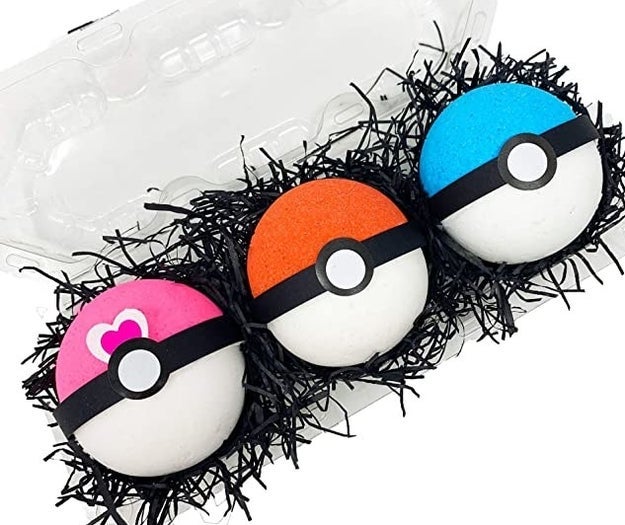 three pokeball bath bombs in pink, red, and blue
