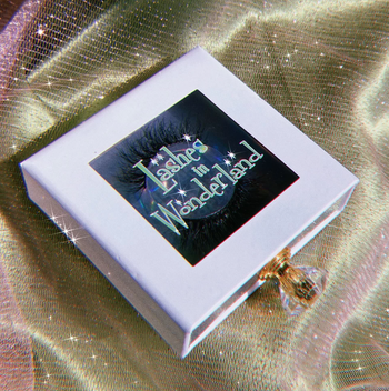 the lashes in a pretty white box with a jeweled handle